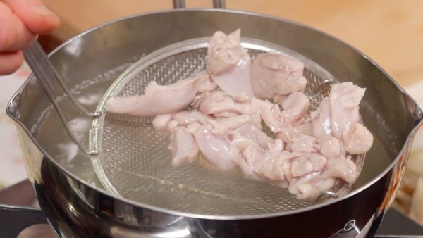 When it turns kind of white, quickly remove the chicken. The parboiling will remove any unwanted flavor from the vegetables and the meat and help them to absorb the broth later, making the dish absolutely delicious.