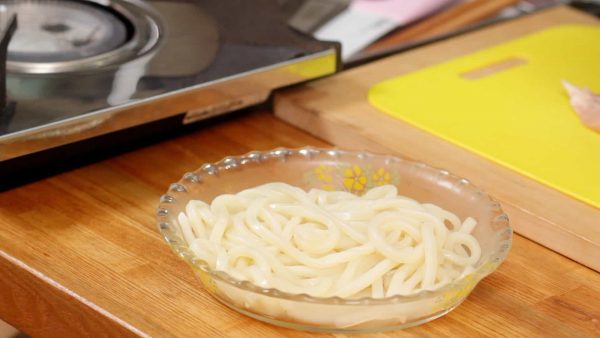 Remove, and place the udon noodles onto a plate.