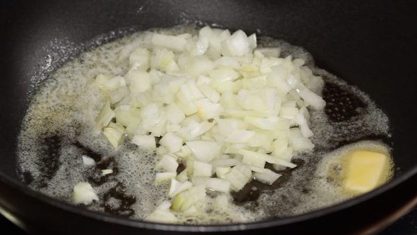 When the butter is melted, add the roughly chopped onion. Saute until it softens.