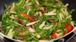 Then, gradually pour in the sauce and continue stir-frying it on high heat.