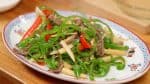 Place the pepper steak also known as chinjao rosu onto a plate.