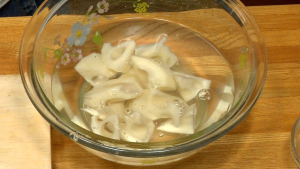 Add vinegar to a bowl of water. Soak the lotus root in the vinegar water. This will keep it from losing its white color.