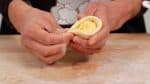Arrange the cream and fold the dough in half. Close the edges in the middle. Then, close the left and right sides.