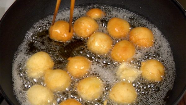 Deep-fry the donuts for 4 to 5 minutes, occasionally turning them over.