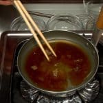 Add the sake, mirin, sugar and soy sauce to the stock. Lightly stir the mixture and turn on the burner.