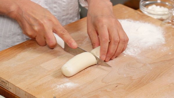 Then, cut the dough in half and cover one with plastic wrap to keep it from drying out.