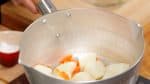 Place it into the pot again. Shake the pot over the heat, removing the excess water.