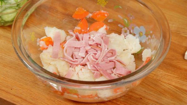 Add the ham to the bowl of the potato.