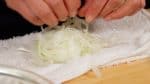Wrap the onion with cheesecloth or a clean dish cloth.