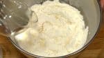 Roughly flatten the flour with your fingers. Gradually mix in two-thirds of the salt water.