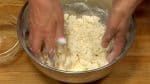 Scoop the moist flour with your hands and mix until crumbly. The dough softness depends on the room temperature, humidity and a type of wheat flour, so gradually add the salt water and adjust as you go. If the dough is too dry and powdery, add the remaining salt water.