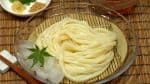 Drain the noodles well and serve them on a dish. Enjoy the udon as soon as possible, otherwise it will become soggy. Spring onion leaves, grated ginger, and sesame seeds go great with noodle soup.