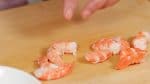 Peel the boiled shrimps and remove the tails. Cut each shrimp in half.
