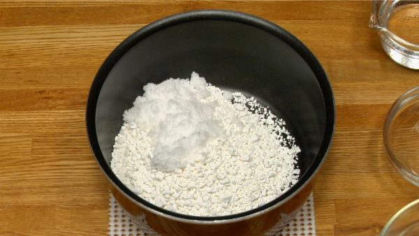 Add the sweet rice flour (mochiko or shiratamok) to a non-stick bowl along with sugar. Stir to combine.