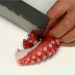 Let's prepare the ingredients for Takoyaki. Dice the boiled octopus into 1.5cm (0.6") pieces.