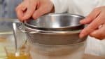 Lalu, dengan menggunakan bagian bawah dari mangkuk kecil, tekan perlahan untuk memeras cairan tapi pastikan kain atau tisu dapur tidak sobek.