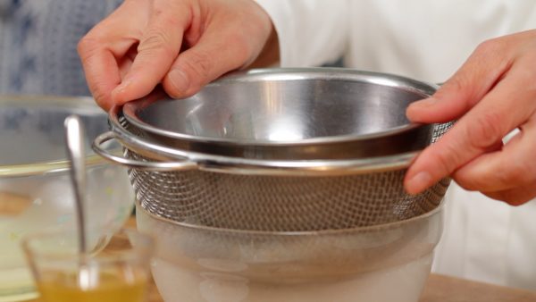 Then, using the bottom of a small bowl, carefully press it to squeeze out the liquid but be sure not to break the paper.