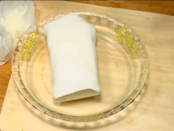 Cool it down and wrap the tofu with a new paper towel. Leave it for a while and then squeeze out the excess water along with the paper towel.