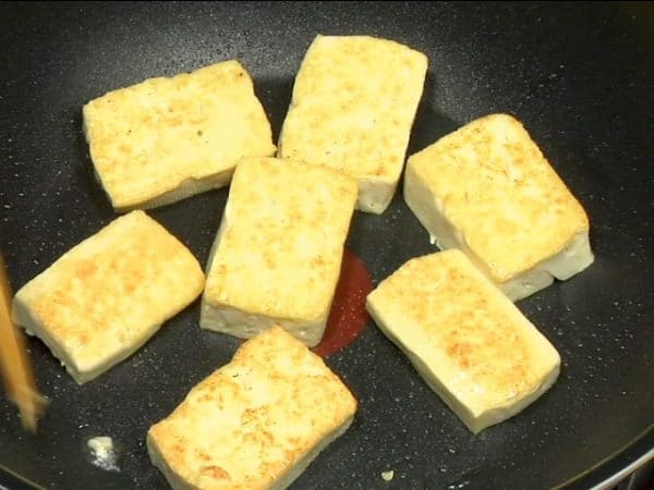 Turn the tofu over. Saute until golden brown and transfer the firm tofu to a bowl.