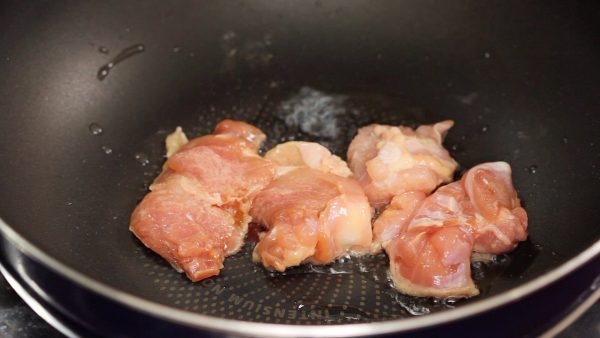 Add vegetable oil to a pan and turn on the burner. Swirl the pan to coat it with the oil. Place the chicken onto the pan with the skin side facing down.