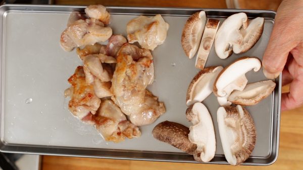 When both sides of the meat are browned, remove and place the chicken onto a tray. You will be simmering the ingredients later so you don't need to cook them completely.