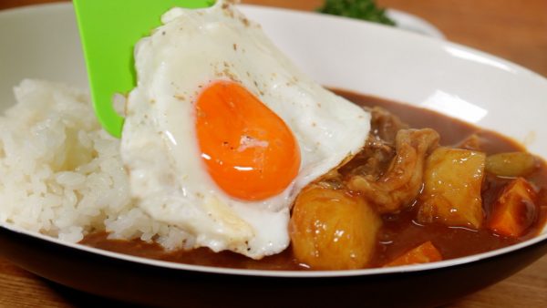 Place the egg sunny-side up onto the curry.