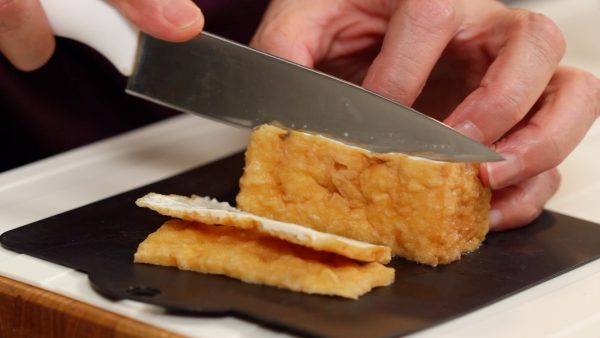First, let’s prepare the atsuage, thick deep-fried tofu. Slice off the fried edges. If atsuage is not available, firm tofu can be used instead but make sure to remove the excess water thoroughly before cooking.