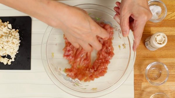 Then, loosely spread your fingers forming a rake shape with your hand to thoroughly mix the meat until it becomes kind of gooey. This will help to combine other ingredients later.