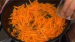 Adding a small amount of water will help the carrot cook quickly. Continue stirring until the carrot softens.