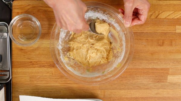 Wet your hands with vegetable oil and spoon the dough onto your hand.