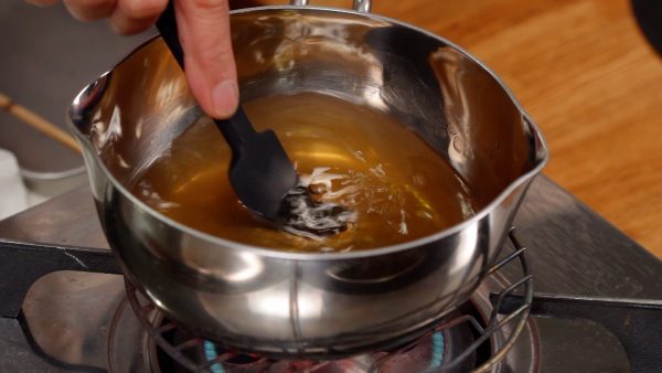 Now, let’s make the sweet vinegar. In a pot, combine the water, raw sugar, regular white sugar and salt. Turn on the burner. Stir to mix.