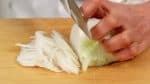 Thinly slice the onion along the grain. New onions are less pungent than regular onions so it is great for salads.
