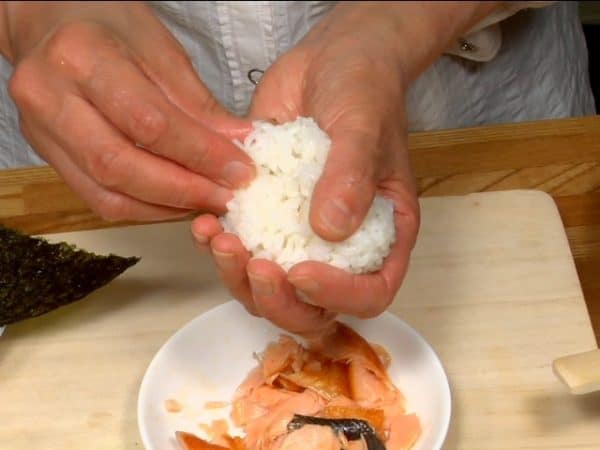 Kumpulkan nasi ke bagian tengah sehingga menutupi isian salmon.