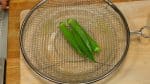 Cook for about 10 seconds, remove and place them on a mesh strainer. Use a paper fan to help the okras cool down faster.