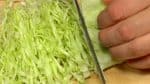 Pile them up and shred the cabbage. Serve the shredded cabbage on the plate.