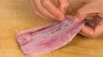 Break the backbone at the tail fin and gently peel it off the fillets.