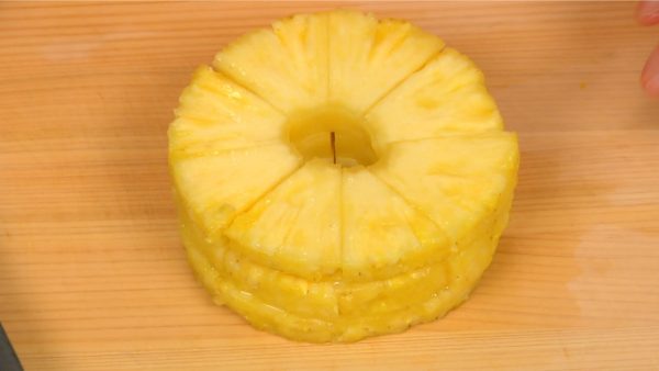 Stack three pineapple rings on top of each other and cut the rings into 8 equal pieces.