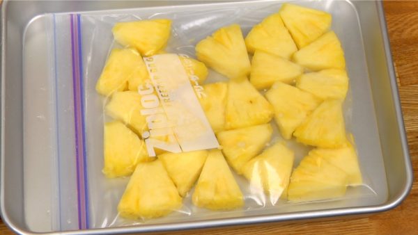 Place the pineapple pieces into a freezer bag and freeze them completely.