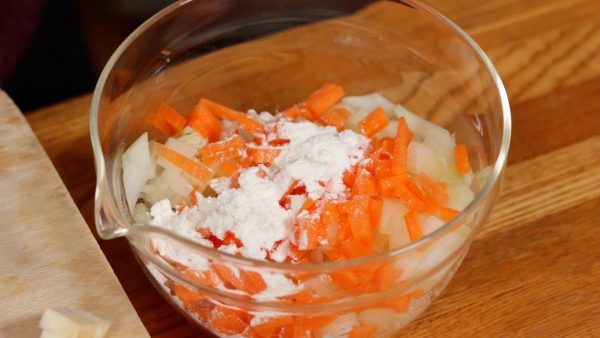 Add the all-purpose flour to the carrot and onion and toss to coat. This will help the fish and vegetables combine well. 