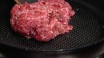 Next, let’s saute the meat. Add the garlic infused olive oil to a pan and turn on the burner. Place the ground beef and pork mixture into the heated pan.