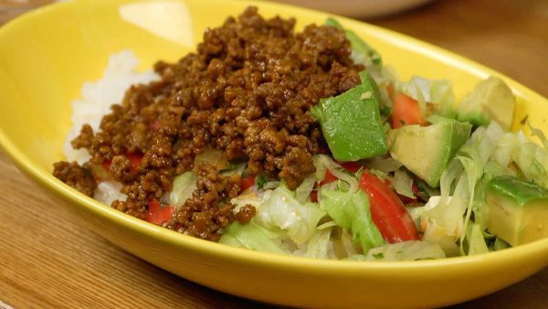 Arrange the avocado on top. Place half of the ground meat mixture next to the vegetables.