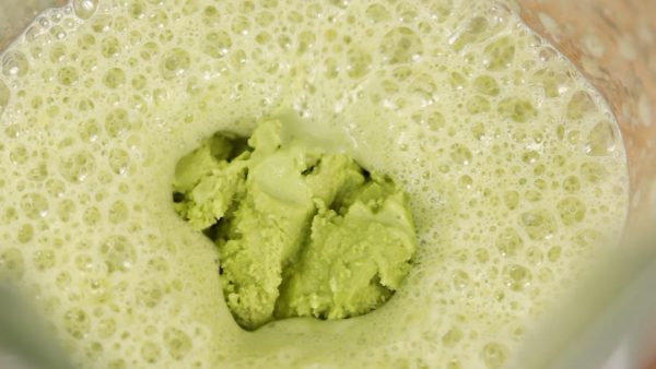 Spoon the matcha ice cream into the blender.