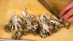 Cut the maitake mushrooms into bite-size pieces.