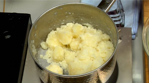 Re-place the pot over the burner. Swish the potatoes in the pot and let the excess water evaporize.