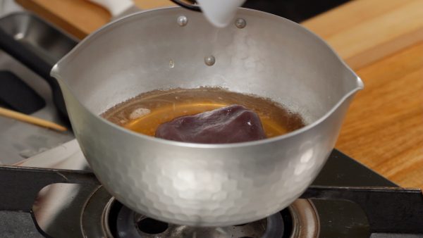 When the sugar is completely dissolved, turn off the burner. Add the koshian, a type of red bean paste which the bean skins are completely removed.