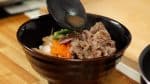 Cover the rest of the rice with a generous amount of the beef slices. Ladle a small amount of the broth over the beef.