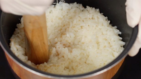 Wet the surikogi pestle and pound the fresh steamed rice in a bowl.