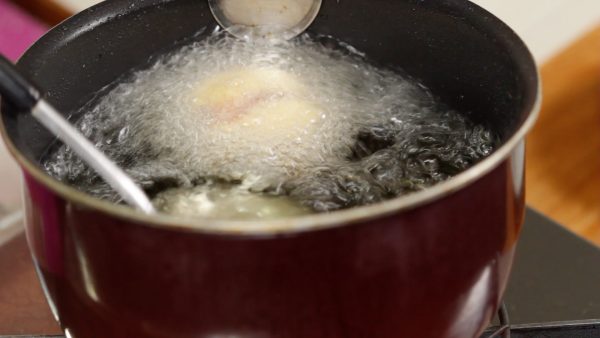 Ladle the hot oil over the ball. Make sure not to touch the ice cream until the outside batter firms up.