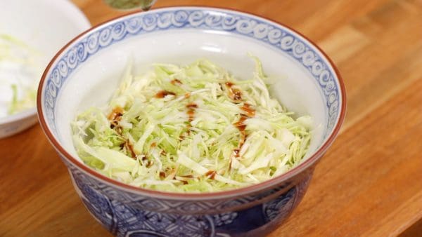 Cover the rice with the shredded cabbage leaves. Drizzle the special sauce over the cabbage.