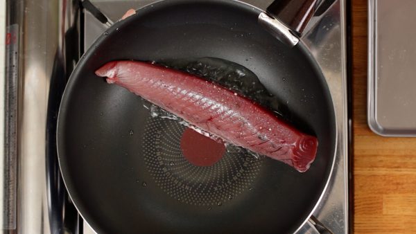 And now, bring the heat to medium high. Place the fillet into the heated pan.